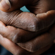 Closeup of an African-American man's clasped hands