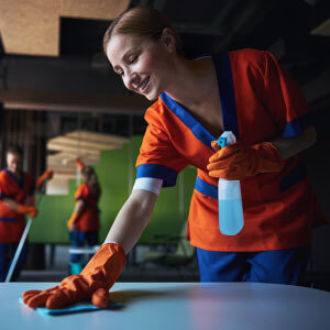 Woman cleaning a table.