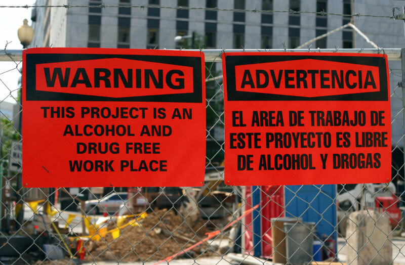 Alcohol and Drug Free Workplace Sign on a construction fence